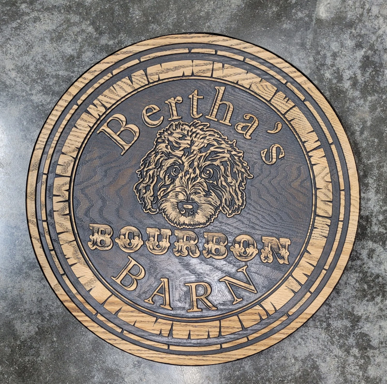 Finished Bourbon Barn sign with gold lettering and a dark background
